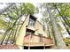 Stylish two-story home featuring a wooden deck and natural surroundings at 5806 Par Four Ct, Lithonia, GA 30038