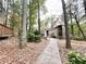 Charming two-story home with a stone pathway and lush forest scenery at 5806 Par Four Ct, Lithonia, GA 30038
