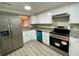 Modern kitchen with stainless steel appliances, white cabinets, and granite counters at 5806 Par Four Ct, Lithonia, GA 30038