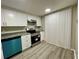 Modern kitchen with granite countertops and teal dishwasher, bright space at 5806 Par Four Ct, Lithonia, GA 30038