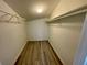 A walk-in closet with wood floors and shelving for ample storage at 5806 Par Four Ct, Lithonia, GA 30038