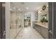 Luxurious bathroom with a modern soaking tub, glass-enclosed shower, double vanity, and access to a walk-in closet at 904 Lenox Ne Blvd, Atlanta, GA 30324