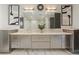 Elegant bathroom featuring a double vanity, marble countertops, decorative mirrors, and modern lighting fixtures at 904 Lenox Ne Blvd, Atlanta, GA 30324