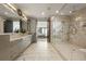 Bright, modern bathroom features double vanity with marble countertops and a glass enclosed shower at 904 Lenox Ne Blvd, Atlanta, GA 30324