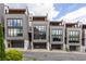 Modern townhome exteriors featuring multi-story design, garage, and private rooftop terraces in a sophisticated urban setting at 904 Lenox Ne Blvd, Atlanta, GA 30324