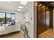 Bright hallway featuring an elevator, stairs with glass railing, and access to the outdoor patio at 904 Lenox Ne Blvd, Atlanta, GA 30324