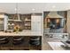 Modern kitchen with stainless steel appliances, large island, bar stools, and open living space at 904 Lenox Ne Blvd, Atlanta, GA 30324