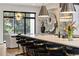 Modern kitchen with a large island, bar seating, and an open dining area with lots of natural light at 904 Lenox Ne Blvd, Atlanta, GA 30324