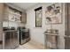 Well-lit laundry room features a stainless steel washer and dryer and utility sink at 904 Lenox Ne Blvd, Atlanta, GA 30324