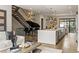 Open-concept living space featuring a modern kitchen, staircase, and grand piano at 904 Lenox Ne Blvd, Atlanta, GA 30324