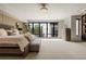 Spacious main bedroom with a large window, stylish chandelier, elegant decor, and ample natural light at 904 Lenox Ne Blvd, Atlanta, GA 30324