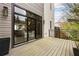 Wooden patio deck with large glass sliding door, potted plants, and a glimpse of the stylish home interior at 904 Lenox Ne Blvd, Atlanta, GA 30324