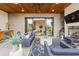 Inviting covered patio with comfortable seating, an outdoor kitchen, and a cozy fireplace at 904 Lenox Ne Blvd, Atlanta, GA 30324