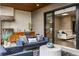 Inviting covered patio with an outdoor kitchen, cozy seating, and sliding door to the home's interior at 904 Lenox Ne Blvd, Atlanta, GA 30324