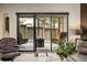 Living room with a view of the outdoor patio with a fire pit and seating at 904 Lenox Ne Blvd, Atlanta, GA 30324