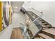 Modern staircase with glass railings and wood steps is accented by decorative wall art at 904 Lenox Ne Blvd, Atlanta, GA 30324
