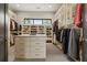 Spacious walk-in closet with custom shelving, an island dresser, and a central window at 904 Lenox Ne Blvd, Atlanta, GA 30324