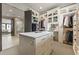 Large walk-in closet boasts custom shelving, a vanity, and access to the ensuite bathroom at 904 Lenox Ne Blvd, Atlanta, GA 30324