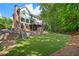 Expansive backyard includes an artificial lawn, play set, and mature trees for privacy at 1835 Berkeley Ne Mews, Atlanta, GA 30329