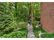 Green backyard with a playset and stone path leads to a firepit and seating at 1835 Berkeley Ne Mews, Atlanta, GA 30329
