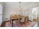 Bright dining room with hardwood floors, wainscoting, and decorative light fixture at 1835 Berkeley Ne Mews, Atlanta, GA 30329