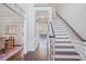 Elegant entryway with hardwood floors, staircase, and views into dining room at 1835 Berkeley Ne Mews, Atlanta, GA 30329