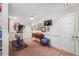 Exercise room with a treadmill, TV, fan, and a wood floor at 1835 Berkeley Ne Mews, Atlanta, GA 30329