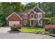 Charming two-story red brick home with manicured lawn and mature trees at 1835 Berkeley Ne Mews, Atlanta, GA 30329