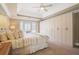 A primary bedroom featuring built-in cabinetry, a ceiling fan, and a bay window at 1835 Berkeley Ne Mews, Atlanta, GA 30329