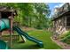 Backyard play area with a slide and swingset perfect for families at 1835 Berkeley Ne Mews, Atlanta, GA 30329