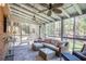 Bright screened porch with ceiling fans, comfortable seating, and a view of the wooded backyard at 1835 Berkeley Ne Mews, Atlanta, GA 30329