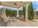 Inviting back porch with stone flooring, ceiling fan, and comfortable seating at 340 Marietta Walk Ln, Marietta, GA 30064