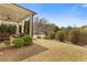 Well-manicured backyard with a covered patio and seating area, and lush green grass at 340 Marietta Walk Ln, Marietta, GA 30064