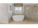 Bright bathroom featuring a soaking tub, walk-in shower and tan tiling at 340 Marietta Walk Ln, Marietta, GA 30064