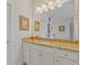Bathroom vanity with decorative framed art pieces, granite countertops, and a large mirror at 340 Marietta Walk Ln, Marietta, GA 30064