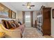 Bedroom with cozy daybed, ornate armoire, ceiling fan, and decorative artwork at 340 Marietta Walk Ln, Marietta, GA 30064