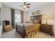 Cozy bedroom with dark wood furnishings, carpeted floor, and a ceiling fan at 340 Marietta Walk Ln, Marietta, GA 30064