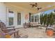 Relaxing covered patio with stone flooring, ceiling fans, and comfortable outdoor furniture at 340 Marietta Walk Ln, Marietta, GA 30064