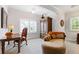 Comfortable bedroom featuring hardwood armoire, chaise lounge, and lots of natural light at 340 Marietta Walk Ln, Marietta, GA 30064