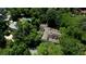 Aerial view of home surrounded by lush trees and landscaping, offering a private and serene setting with a backyard pool at 468 W Paces Ferry Rd, Atlanta, GA 30305