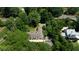 Aerial view of a home surrounded by lush trees and landscaping, offering a private and serene setting near a road at 468 W Paces Ferry Rd, Atlanta, GA 30305