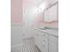 This stylish bathroom features pink walls, white wainscoting, and a vanity with a marble countertop at 468 W Paces Ferry Rd, Atlanta, GA 30305