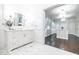 Bathroom with marble vanity and view into closet with custom cabinets and island at 468 W Paces Ferry Rd, Atlanta, GA 30305