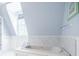 Bright bathroom features a large tub, tile floors, and marble walls, with natural light from a large window at 468 W Paces Ferry Rd, Atlanta, GA 30305