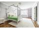 Spacious bedroom featuring a canopy bed, window with natural light, and built-in shelves at 468 W Paces Ferry Rd, Atlanta, GA 30305