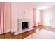 A bright and airy bedroom with marble fireplace and pink walls at 468 W Paces Ferry Rd, Atlanta, GA 30305