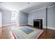 A spacious bedroom with hardwood floors, a fireplace, and a large rug beneath the bed at 468 W Paces Ferry Rd, Atlanta, GA 30305
