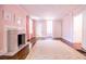 Spacious bedroom with marble fireplace, pink walls, hardwood floors, and natural light at 468 W Paces Ferry Rd, Atlanta, GA 30305
