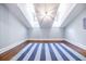 Bright bedroom features vaulted ceiling, hardwood floors and a blue and grey striped rug at 468 W Paces Ferry Rd, Atlanta, GA 30305