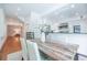 Bright dining room features hardwood floors, wooden table with white chairs, and a view into the modern kitchen at 468 W Paces Ferry Rd, Atlanta, GA 30305